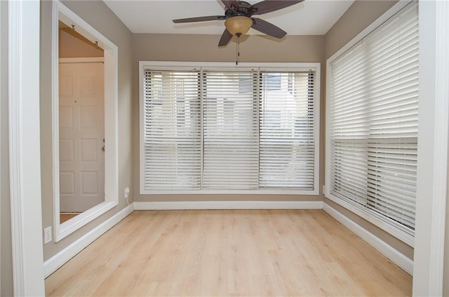 unfurnished sunroom featuring a ceiling fan