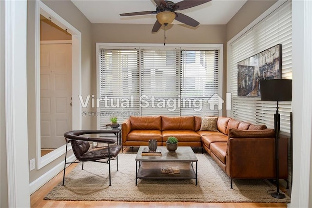 living area featuring ceiling fan, wood finished floors, and baseboards