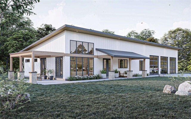 rear view of house featuring a lawn and a patio area