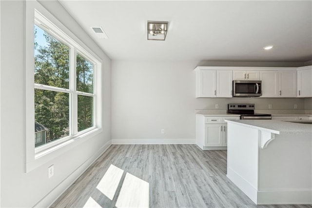 6075 Quail Mountain Trl, Gainesville, GA 30506 - kitchen with appliances with stainless steel finishes, light countertops, white cabinets, and recessed lighting