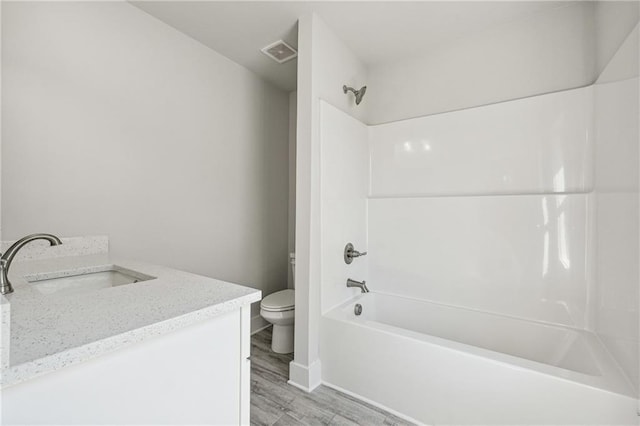 6075 Quail Mountain Trl, Gainesville, GA 30506 - bathroom with toilet, vanity, washtub / shower combination, wood finished floors, and baseboards