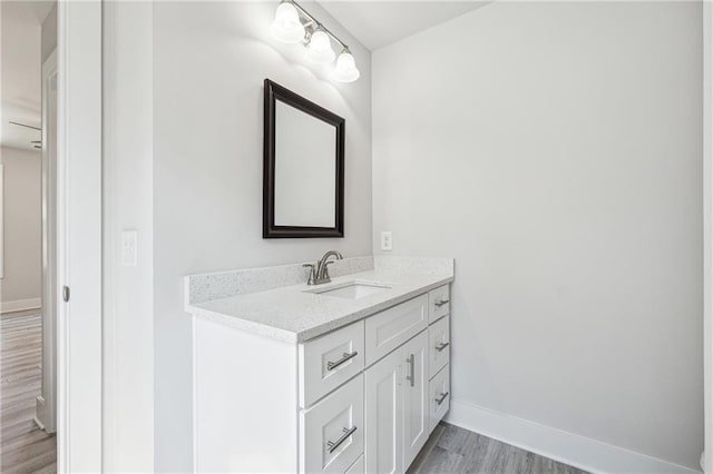 6075 Quail Mountain Trl, Gainesville, GA 30506 - bathroom featuring wood finished floors, vanity, and baseboards