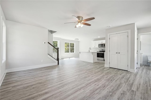 6075 Quail Mountain Trl, Gainesville, GA 30506 - unfurnished living room with a ceiling fan, stairway, light wood-type flooring, baseboards, and recessed lighting