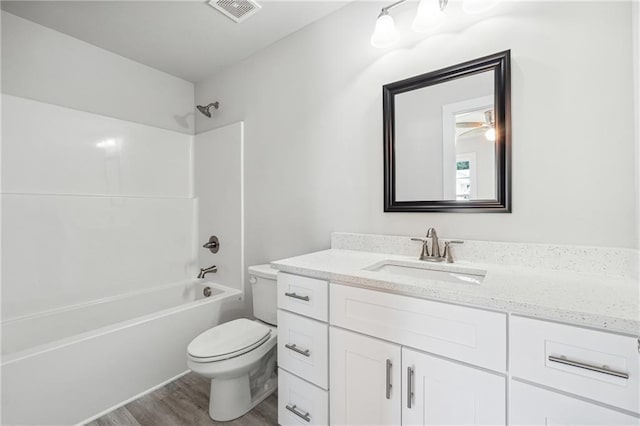 6075 Quail Mountain Trl, Gainesville, GA 30506 - bathroom with toilet, vanity, wood finished floors, and shower / bath combination