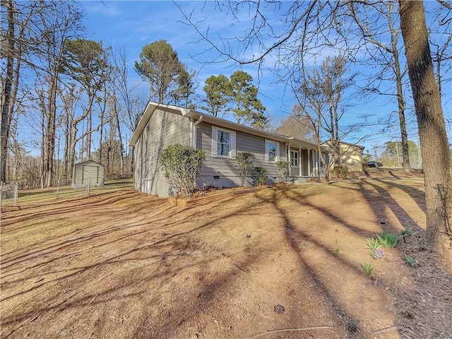 view of front facade with an outbuilding, crawl space, and dirt driveway