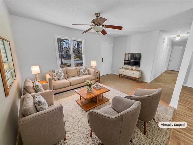 carpeted living room with ceiling fan and a textured ceiling