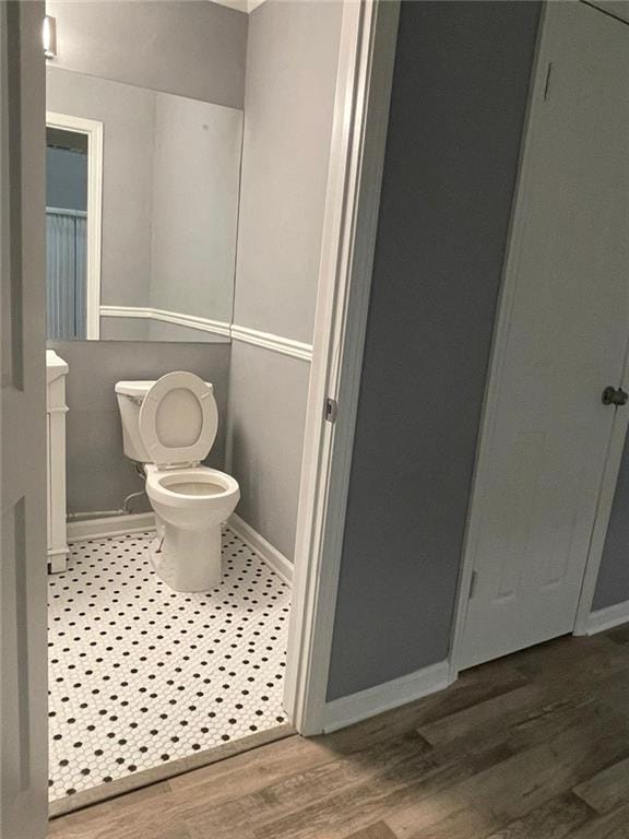 bathroom featuring hardwood / wood-style flooring and toilet