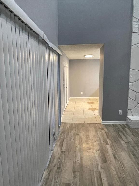 corridor with hardwood / wood-style floors