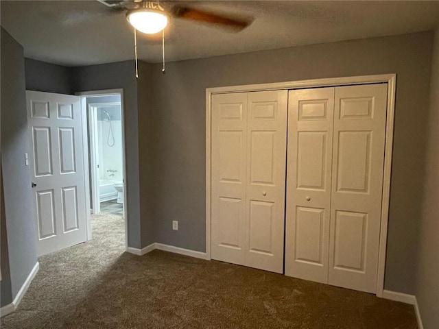 unfurnished bedroom with ceiling fan, a closet, and dark carpet