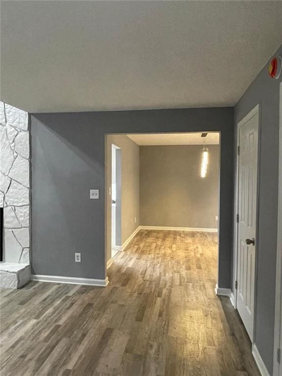 interior space with wood-type flooring and a textured ceiling