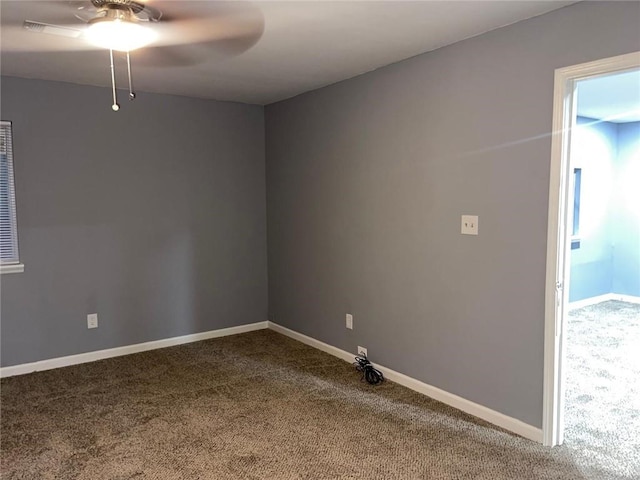 empty room featuring ceiling fan and carpet floors