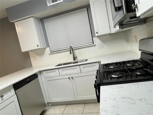 kitchen with gas stove, white cabinetry, dishwasher, and sink