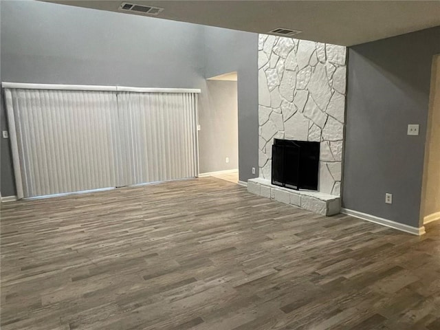 unfurnished living room featuring a fireplace and wood-type flooring