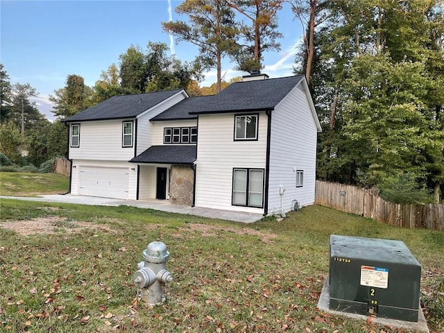 view of front of house with a front yard and a garage