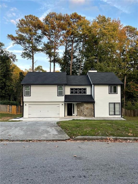 view of front of home with a garage and a front yard