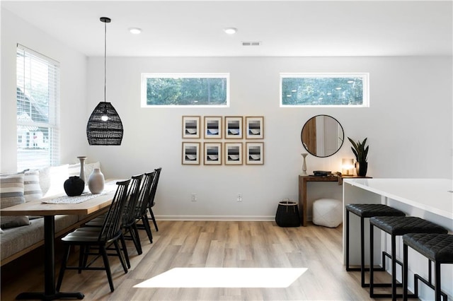 dining area featuring a wealth of natural light and light hardwood / wood-style floors