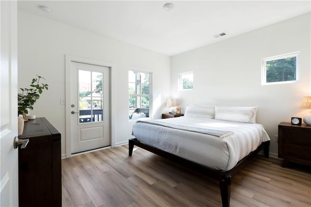 bedroom featuring access to exterior and light hardwood / wood-style floors