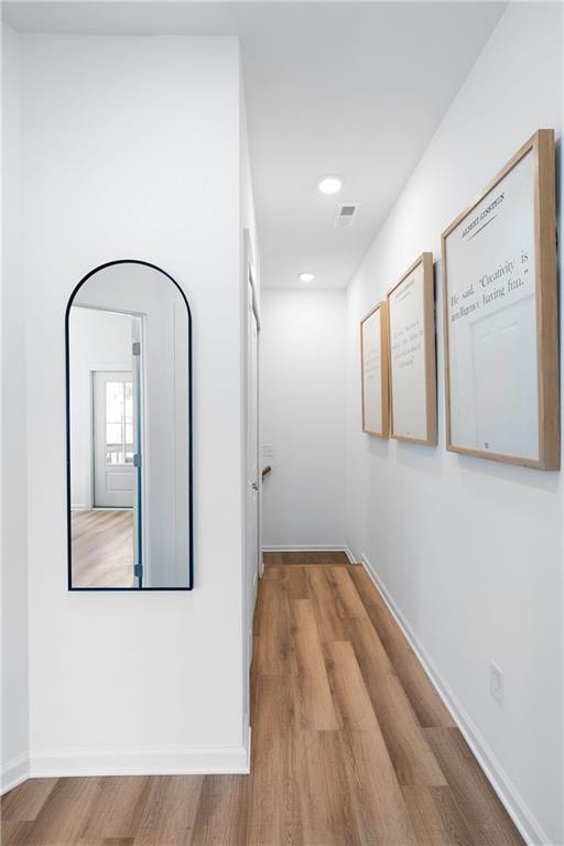 hall with wood-type flooring