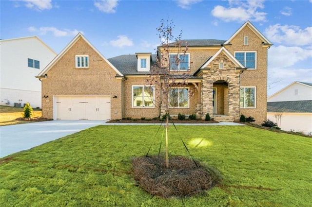view of front of home with an attached garage, a front lawn, brick siding, and concrete driveway