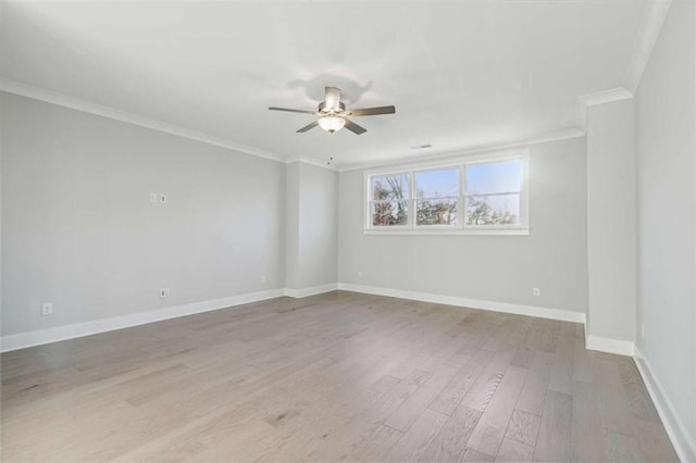 unfurnished room featuring ceiling fan, baseboards, ornamental molding, and wood finished floors