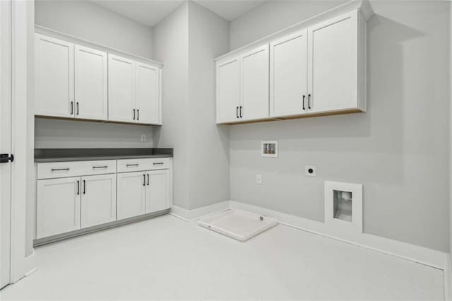 clothes washing area featuring electric dryer hookup, cabinet space, and washer hookup