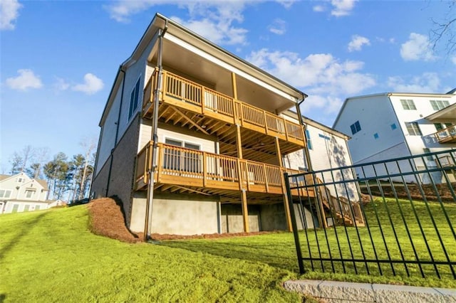 rear view of property with a lawn and stairway