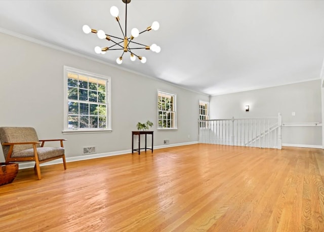 interior space with light wood-type flooring, baseboards, visible vents, and a notable chandelier