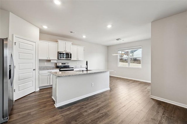 kitchen featuring dark wood-style flooring, stainless steel appliances, white cabinetry, a sink, and baseboards