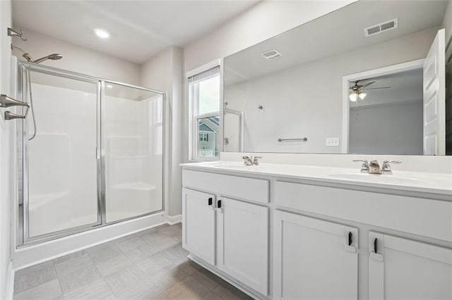 full bathroom with a stall shower, visible vents, and a sink