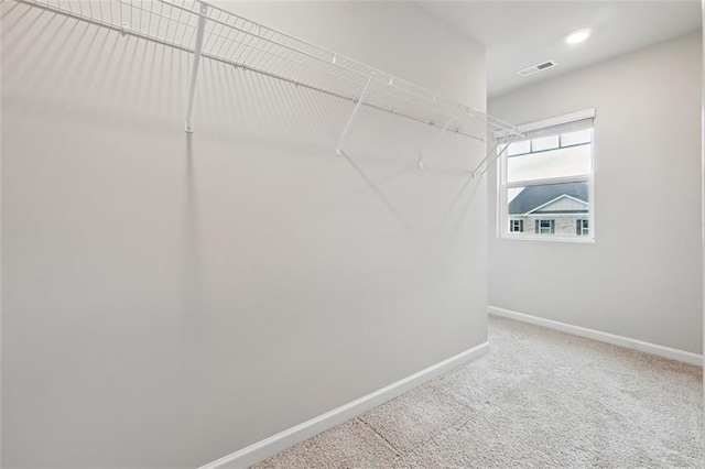 walk in closet featuring carpet and visible vents