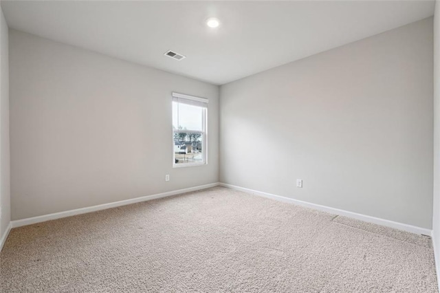 unfurnished room featuring recessed lighting, carpet flooring, visible vents, and baseboards