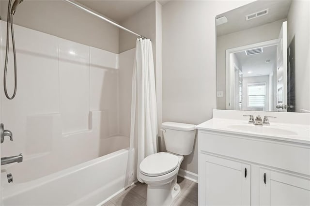 full bathroom featuring toilet, visible vents, shower / tub combo with curtain, and vanity