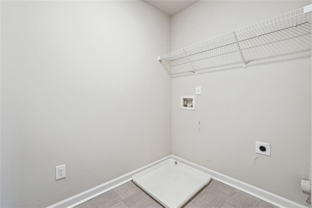 clothes washing area featuring laundry area, baseboards, washer hookup, and hookup for an electric dryer