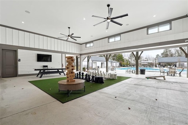 view of patio featuring a community pool and a ceiling fan