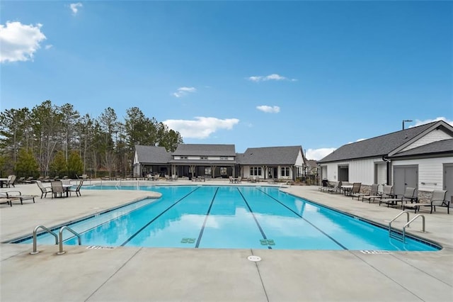 pool featuring fence and a patio