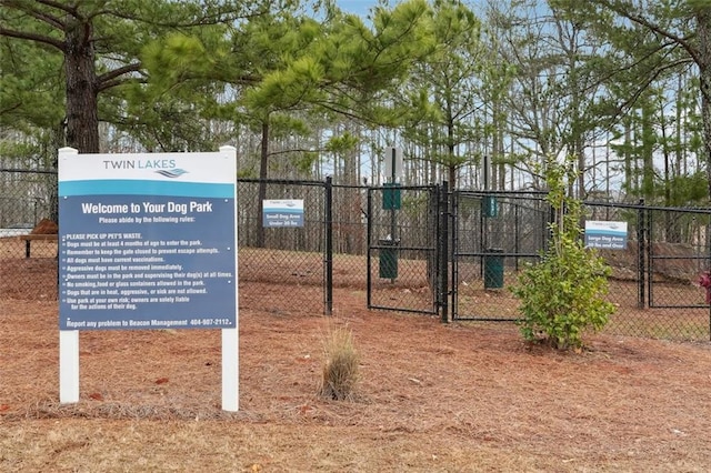 view of property's community with a gate and fence