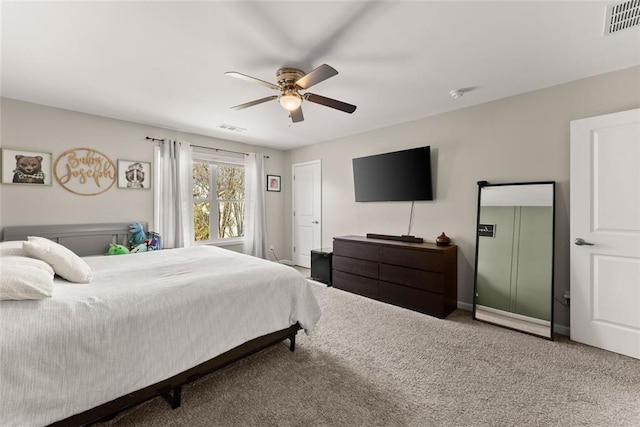 carpeted bedroom with ceiling fan, visible vents, and baseboards