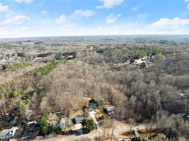 drone / aerial view featuring a view of trees