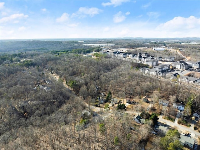 birds eye view of property with a view of trees