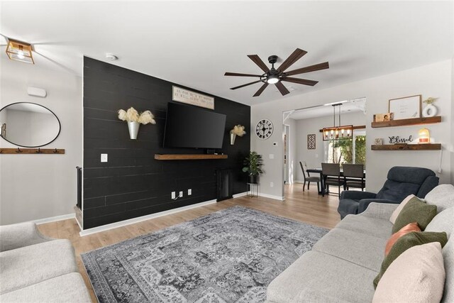 living room featuring ceiling fan and light hardwood / wood-style flooring