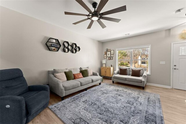 living room featuring light hardwood / wood-style floors and ceiling fan