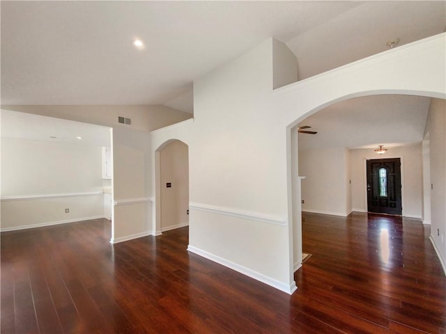 unfurnished room featuring dark hardwood / wood-style flooring and lofted ceiling