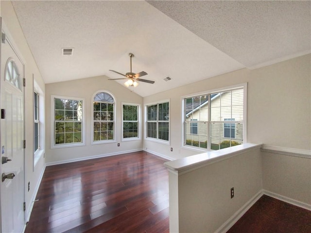 unfurnished sunroom featuring ceiling fan and lofted ceiling