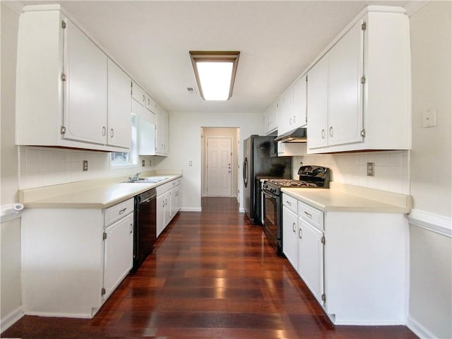 kitchen with white cabinets, dark hardwood / wood-style floors, tasteful backsplash, and black appliances