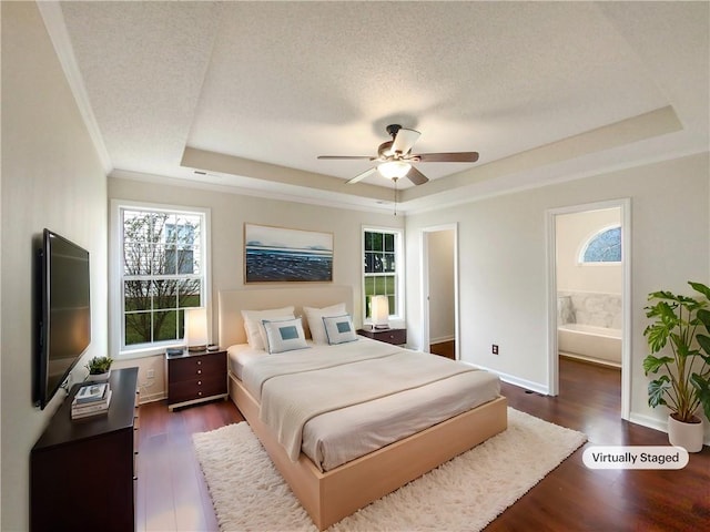 bedroom featuring connected bathroom, dark hardwood / wood-style floors, and multiple windows