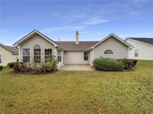 back of house with a yard and a patio