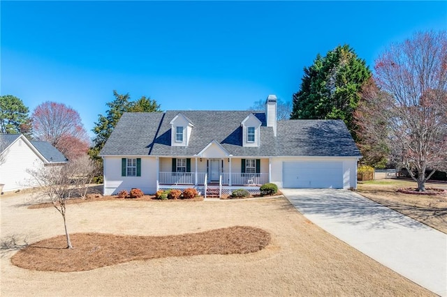 cape cod house featuring covered porch, driveway, a chimney, and a garage