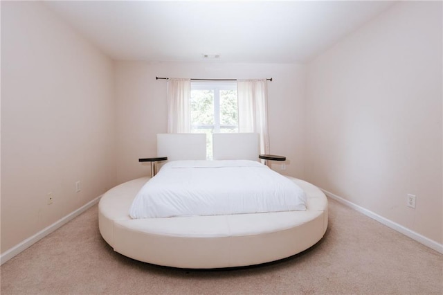 carpeted bedroom featuring visible vents and baseboards