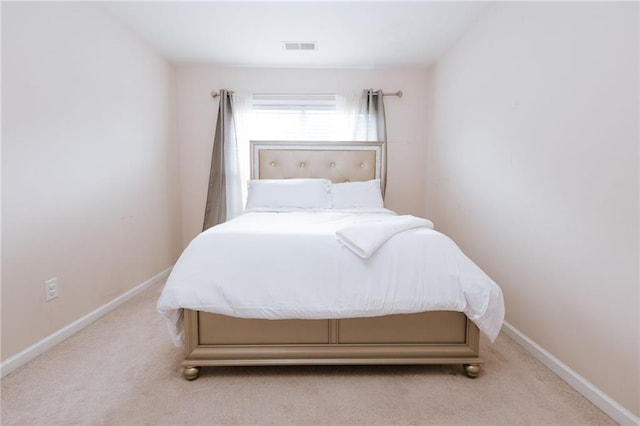 bedroom featuring light carpet, visible vents, and baseboards