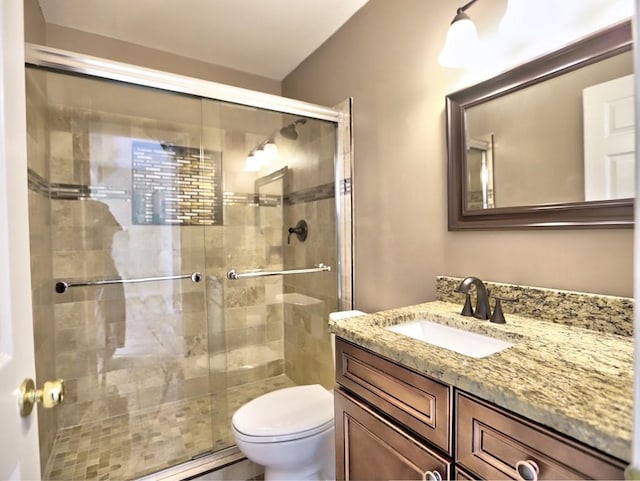 bathroom with vanity, toilet, and an enclosed shower